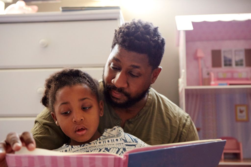 Father reading to daughter