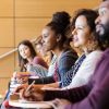 Diverse college students seated in row in lecture hall