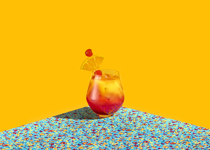 Red and Yellow cocktail shot over a graphic colorful background