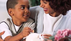 Mother and son with piggy bank