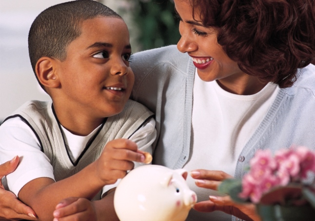 Mother and son with piggy bank