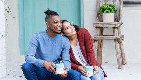 African-American couple hanging out, drinking coffee