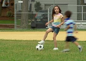 MS Boy and girl playing soccer on baseball diamond/ Fanwood, New Jersey