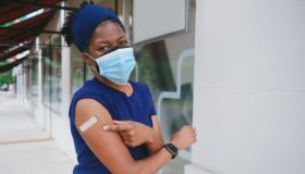 Woman Smiles Outdoors After Receiving COVID-19 Vaccine