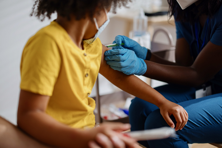 Little girl taking a vaccine from her doctor, pediatrist