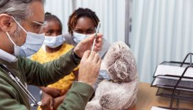 Pediatrician preparing to give child a COVID-19 vaccination