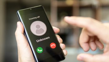 Phone call from unknown number. Scam, fraud or phishing with smartphone concept. Prank caller, scammer or stranger. Man answering to incoming call. Hoax person with fake identity.