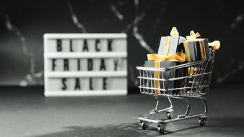 Black Friday sale with shopping cart and copy space