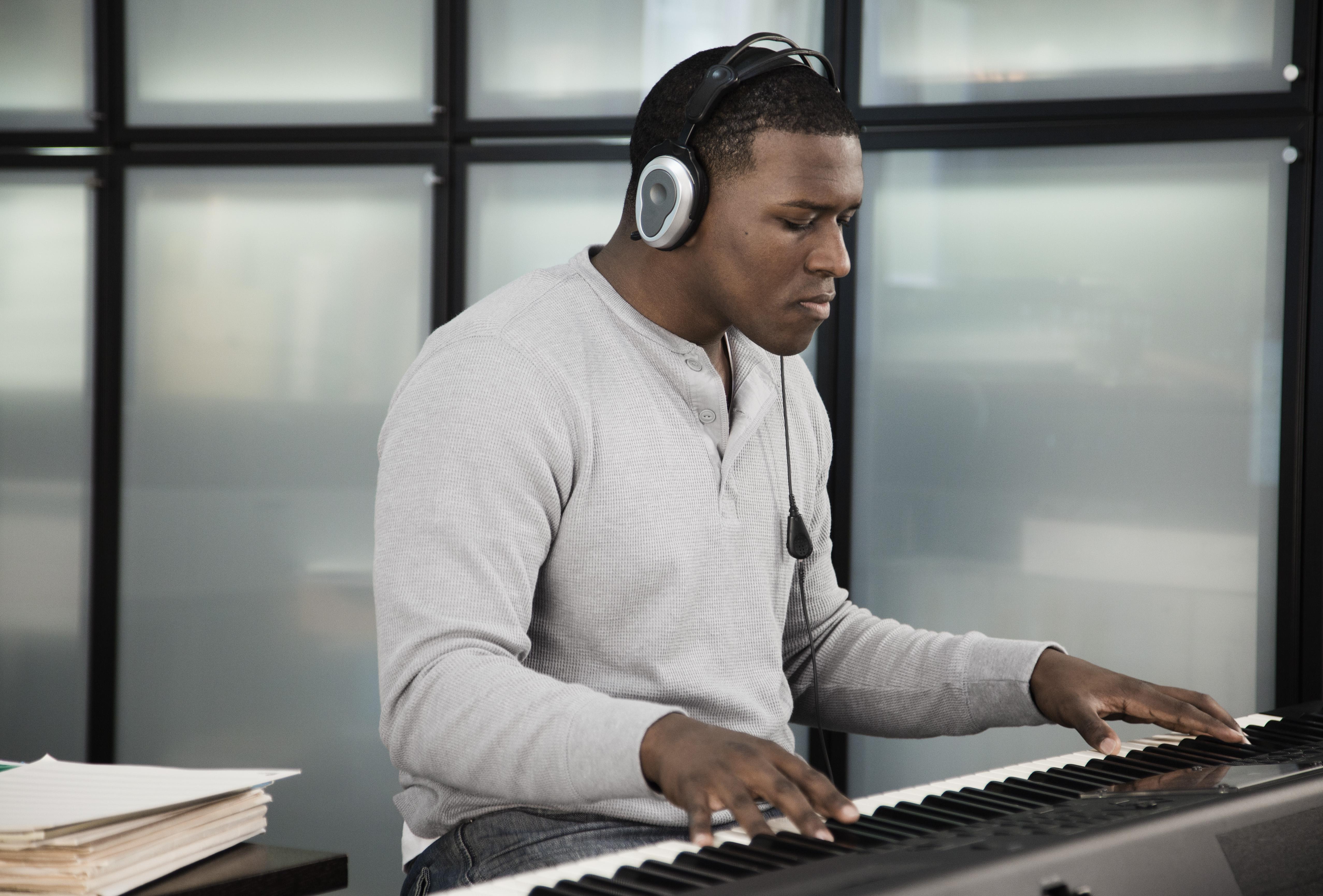 Black man playing electronic keyboard