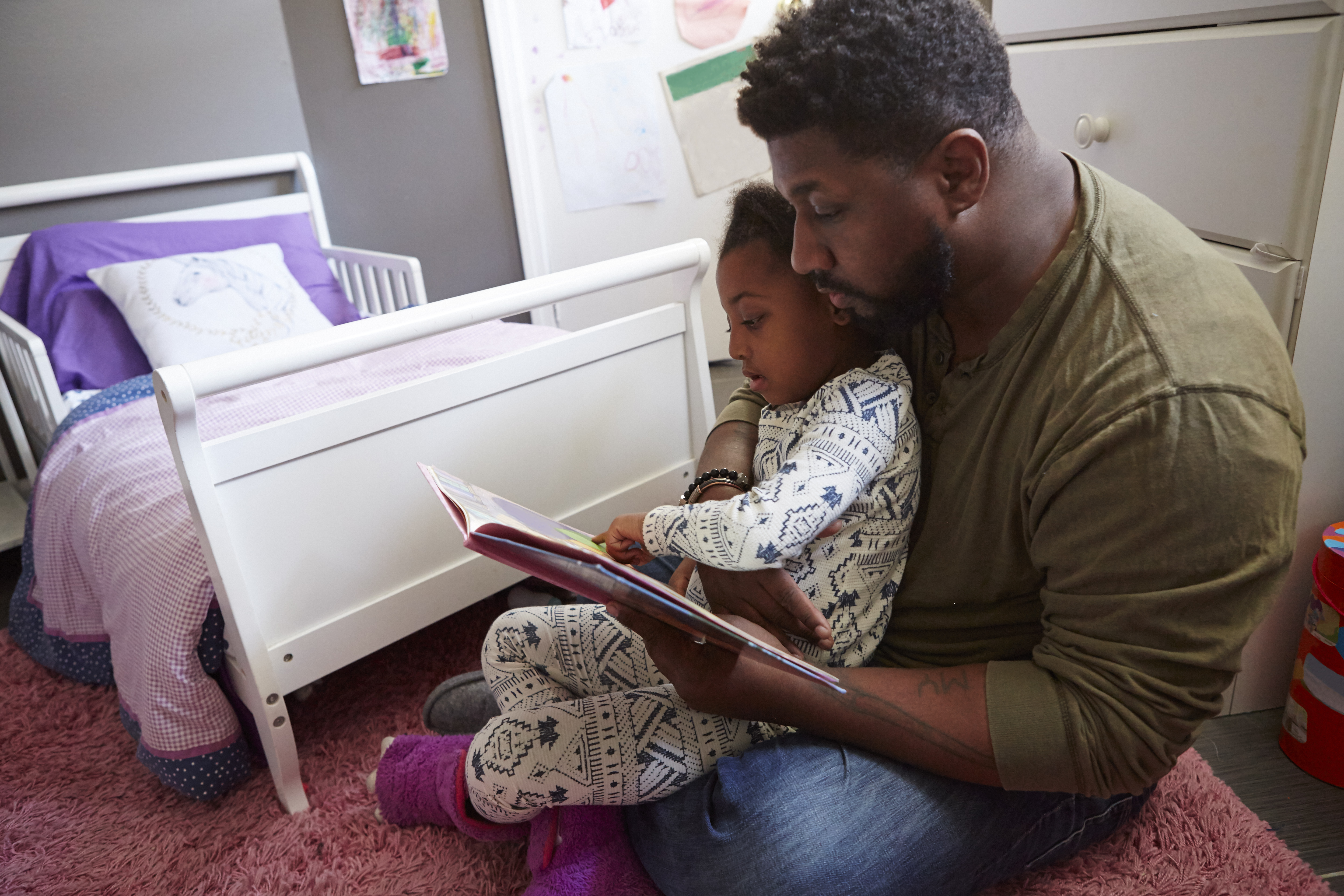 Father reading to daughter