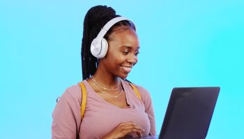 Black woman, laptop and typing to search internet, social media and connection on studio background listening music. Female, African lady and device for conversation, online reading, playlist and relax for planning or mockup