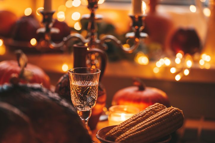 Thanksgiving holiday dinner table setting with fall decoration and pumpkins