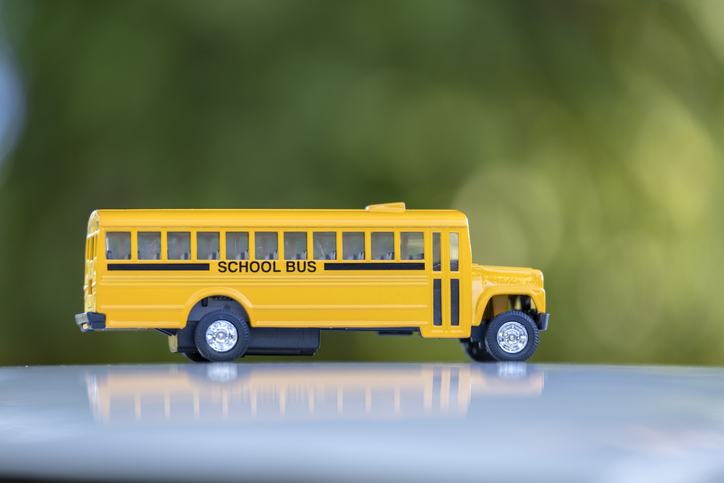 Little model of american yellow school bus outdoor. Concept of education safety in the USA