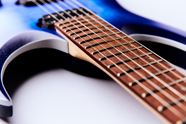 Fretboard of modern electric guitar. Close up.