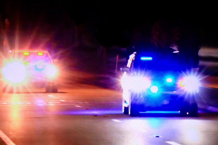 In pursuit, Cop cars driving at night