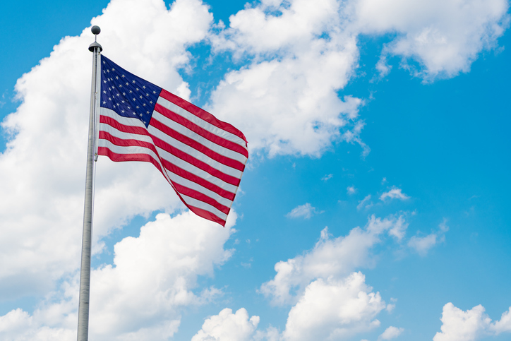 Flag of the USA. National waving flag of united states on blue sky. Independence day. Patriotic symbol. American Flag for Memorial Day or 4th of July. American flag. Day of independence